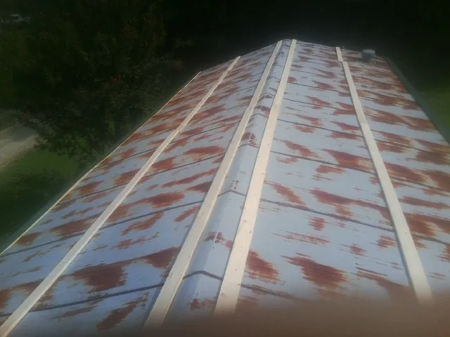 Rusted metal roof panels with new wood purlins before replacement — Storm Damage Roof Repair in Ellettsville by Roofing Brothers